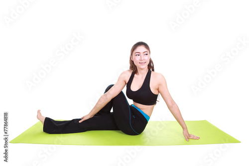 Young woman doing yoga exercise with yoga mat