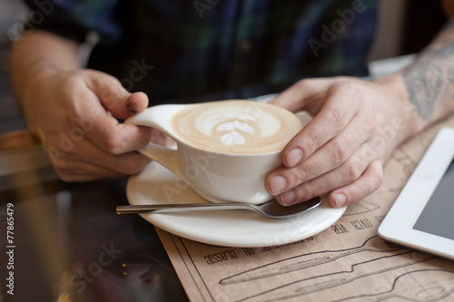 Dirty hands with cup of coffee