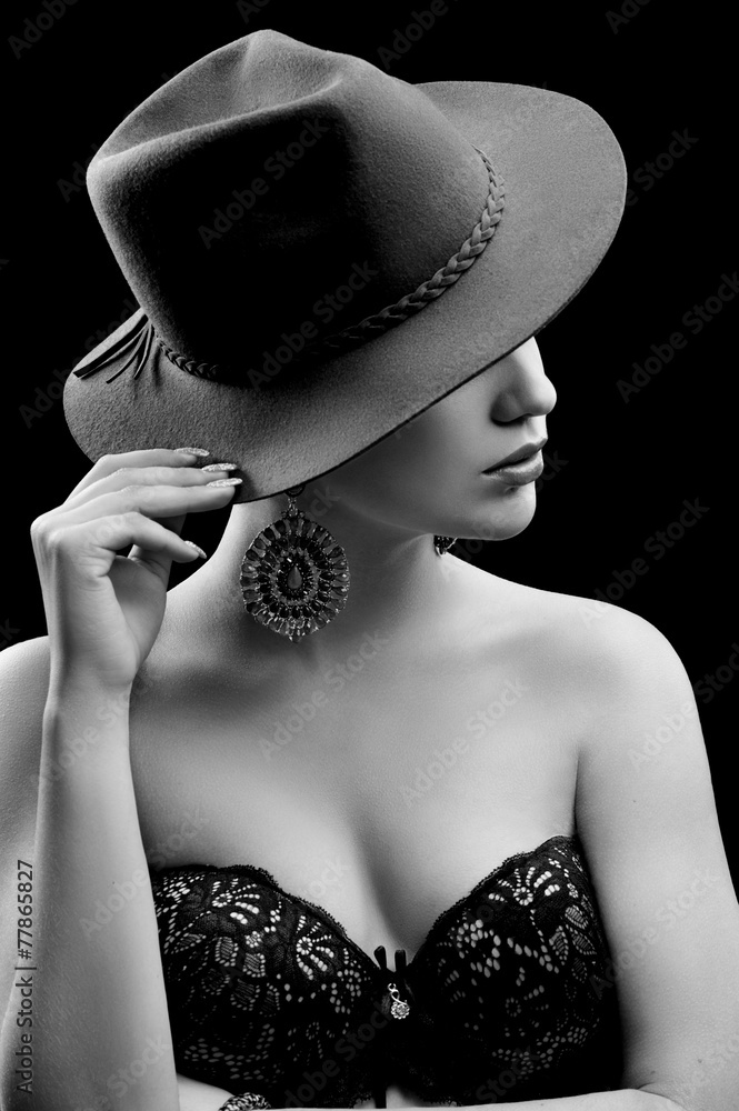 Fototapeta premium Portrait of beautiful sexy girl in black and white hat