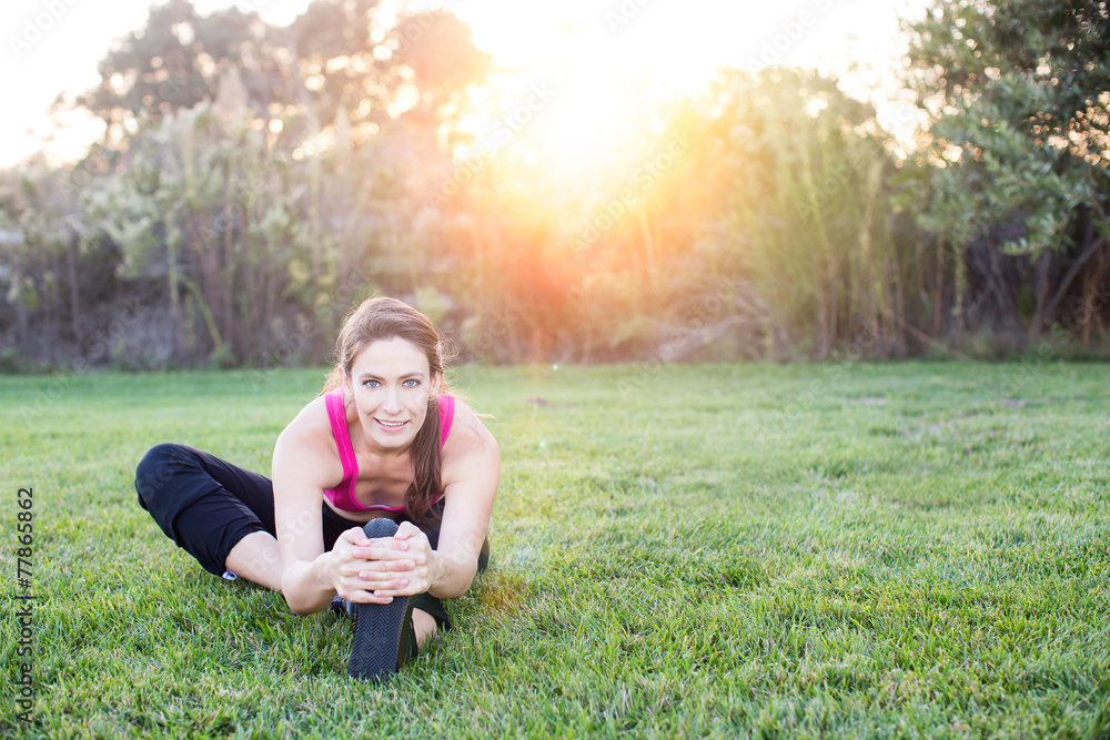 Fototapeta premium Woman stretching at the park