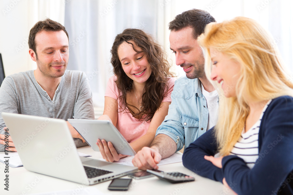 Group of 4 young attractive people working on a laptop Group of 4 young attractive people working on a laptop