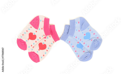 Tow pairs of girl and boy socks with hearts isolated on white.