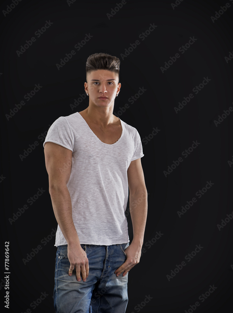 Fototapeta premium Attractive trendy young man standing on black background