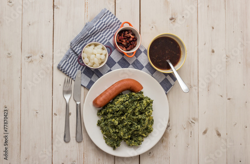 Boerenkool with smoked sausage on a white plate photo