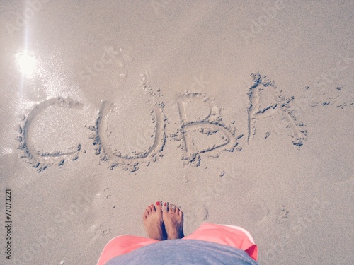 word Cuba outline on the wet sand, holiday concept photo