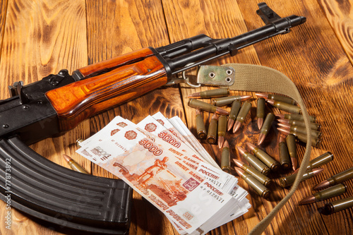 Kalashnikov rifle and Russian rubles