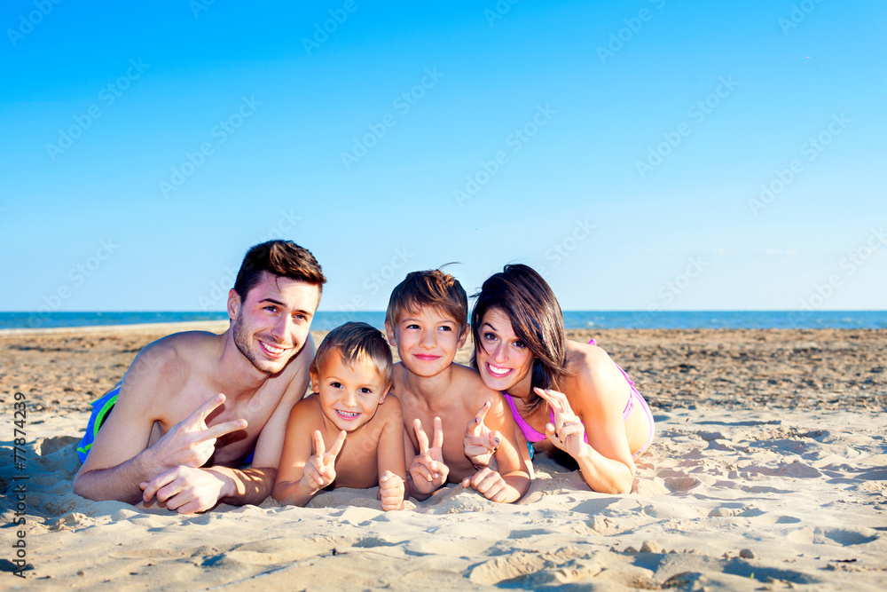 happy family posing for a souvenir photo at the sea happy family posing for a souvenir photo at the sea