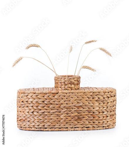 Wicker vase with wheat ears.