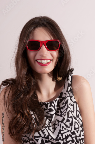Pretty woman portrait in red sunglasses