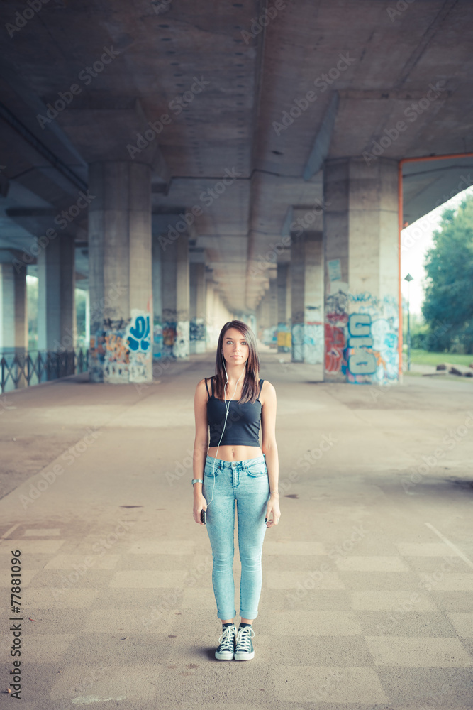 Fototapeta premium young beautiful brunette straight hair woman listening music