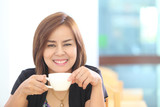 woman drinking coffee in the morning at restaurant
