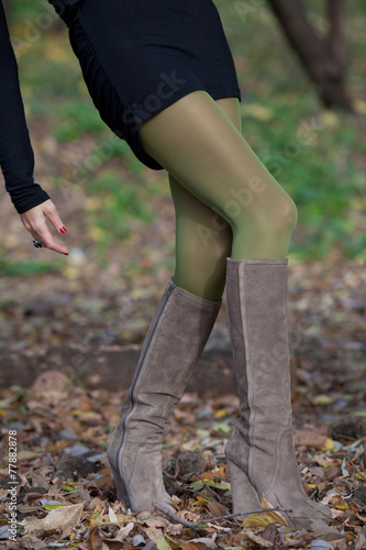 Shapely female legs are on the fall foliage © glebchik