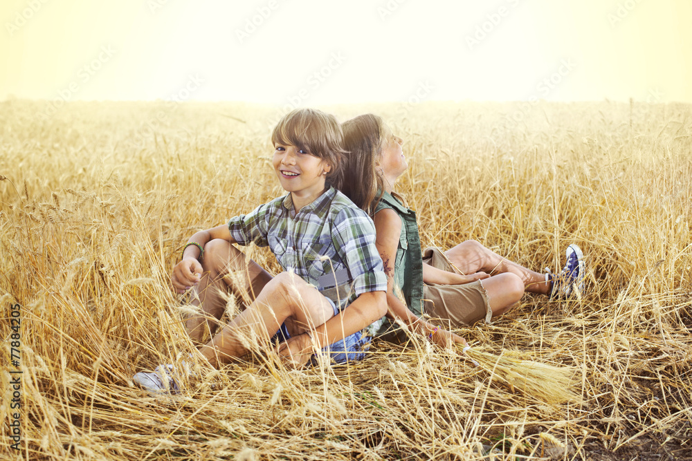 Children having fun in an wheat field at sunset Children having fun in an wheat field at sunset