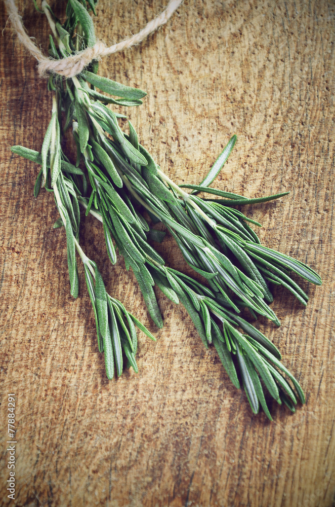 toning effect sprigs of rosemary on a wooden board closeup horiz toning effect sprigs of rosemary on a wooden board closeup horiz