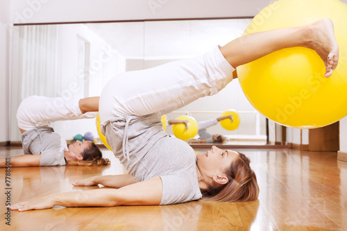 women making fitness exercises with ball photo