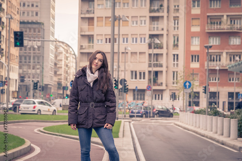 Young beautiful girl posing in the city streets