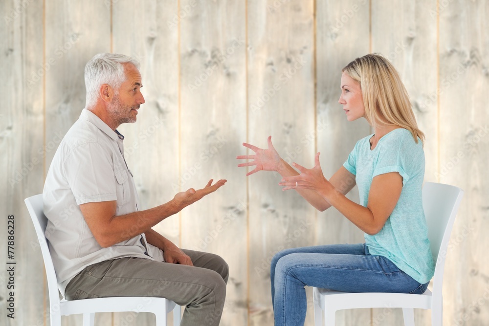 Obraz premium Unhappy couple sitting on chairs having an argument