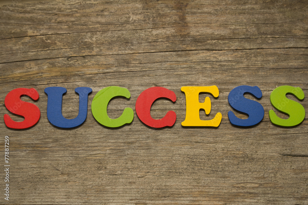 Fototapeta premium text success on a wooden background