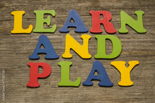 Learn and Play (colorful letters on a wooden background)