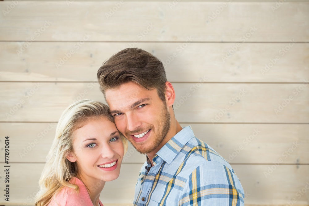 Composite image of attractive couple smiling at camera Composite image of attractive couple smiling at camera