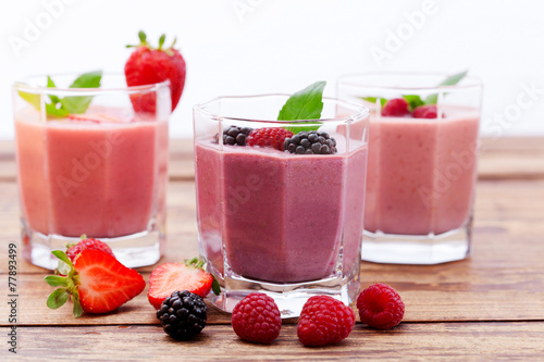 Drink smoothies summer strawberry, blackberry on wooden table.