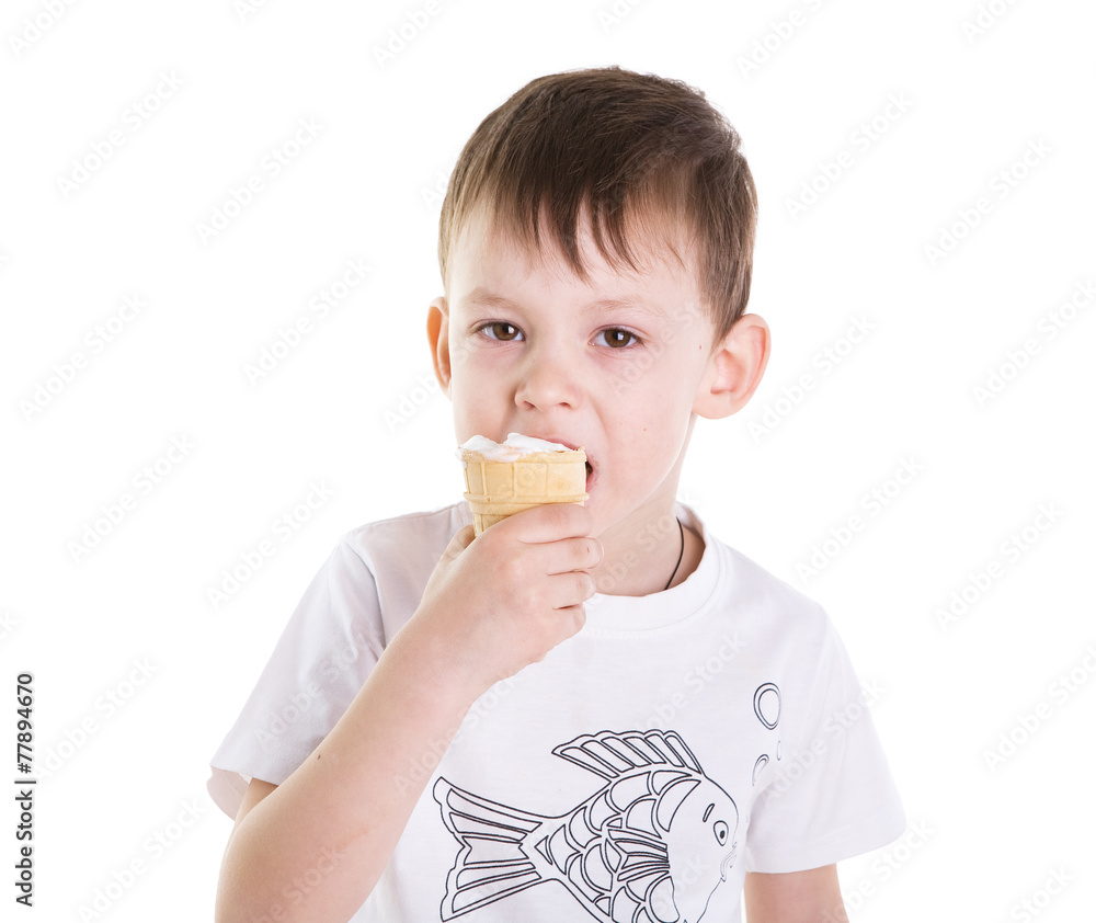 the little beautiful boy eats cold ice cream. Isolated the little beautiful boy eats cold ice cream. Isolated