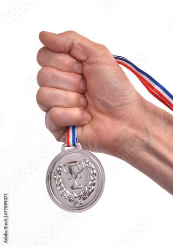 Vencedor celebrando triunfo sujetando una medalla de plata. photo