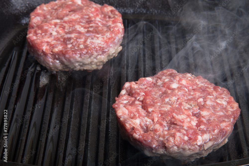 Two beef cutlets on the grill frying pan Two beef cutlets on the grill frying pan