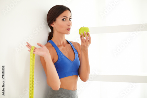 Health-conscious latin lady dieting on apple