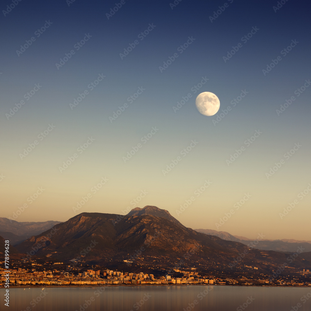 Fototapeta premium Mythical Moonrise Over Mountains And Water