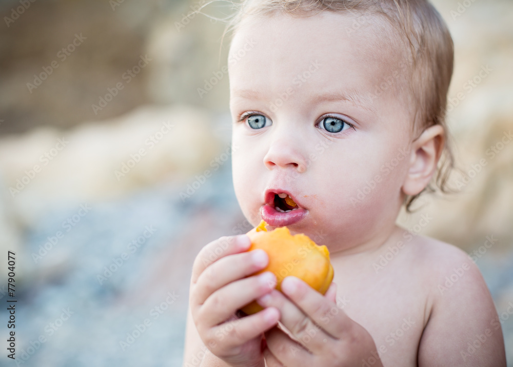 Cute Toddler boy eating an apricot Cute Toddler boy eating an apricot