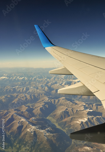 Plane wing over mountains