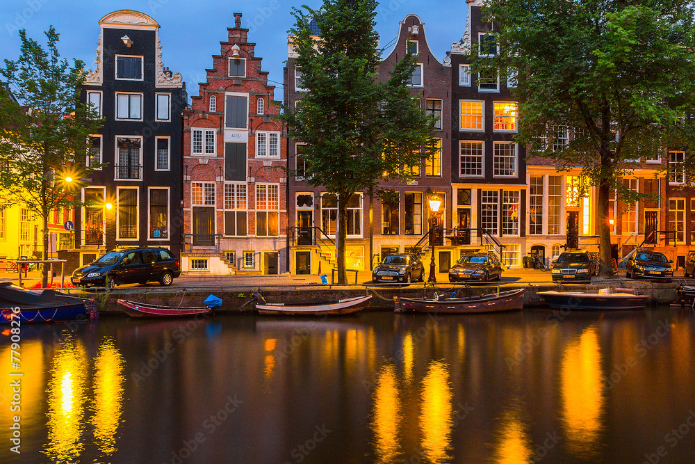 Night illumination of Amsterdam canal and bridge 