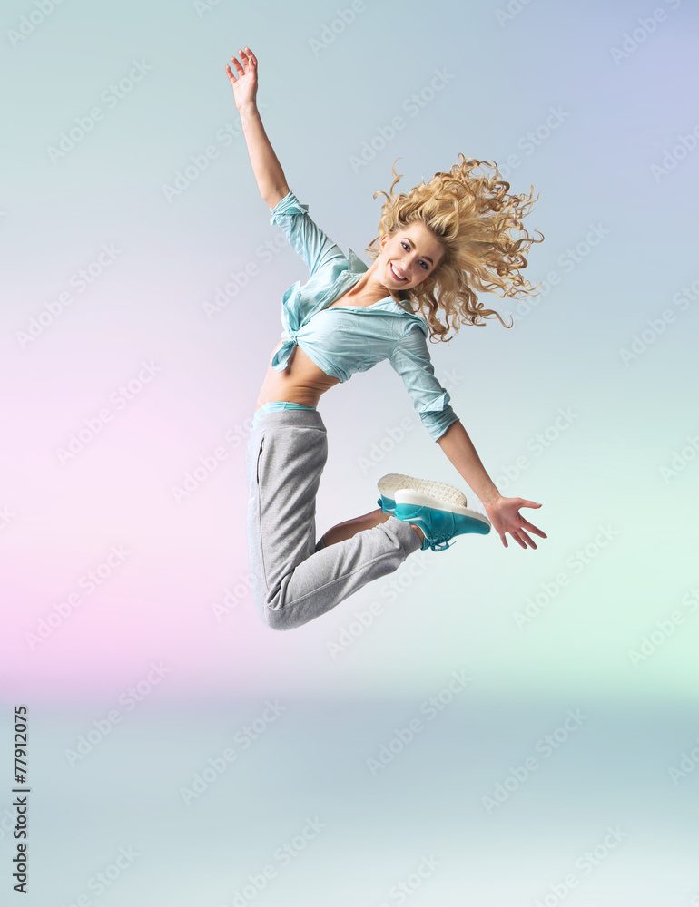 Curly-haired athlete woman jumping and dancing Curly-haired athlete woman jumping and dancing