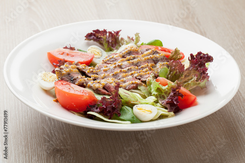 Fresh beef salad with lettuce, tomatoes, boiled eggs, mustard sa