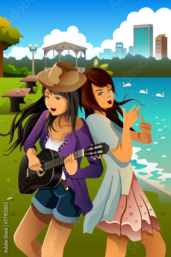 Teenage girls singing and playing guitar together