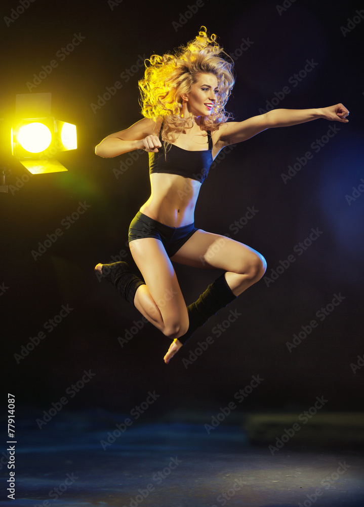 Young sexy girl jumping on rehearsal