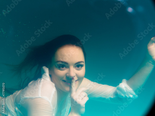 Underwater girl wearing bikini in swimming pool photo