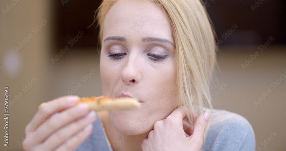 Attractive woman eating homemade pizza Attractive woman eating homemade pizza