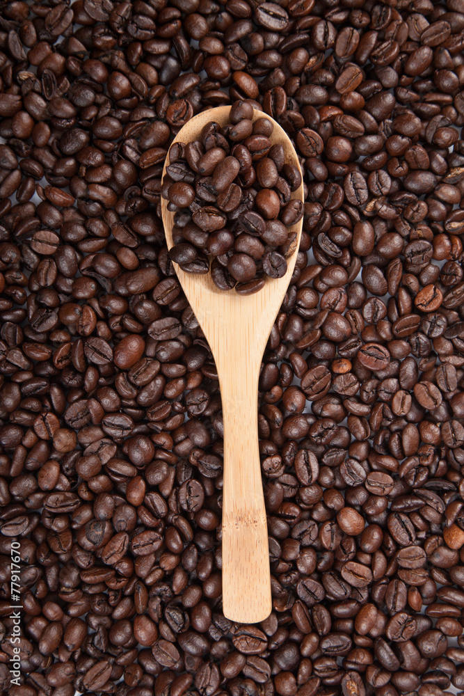 Fototapeta premium Roasted coffee beans with wooden spoon