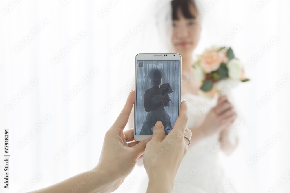 Women who are taking the bride photo on mobile phone