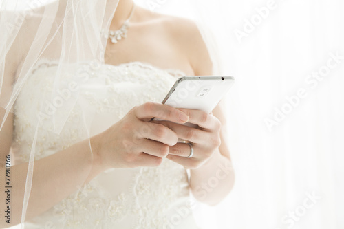 Bride is sending an email on mobile phone