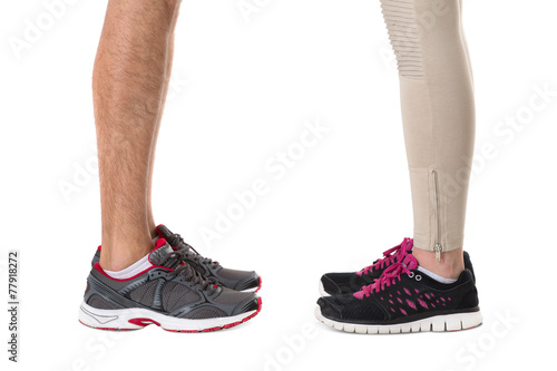 Man and woman in sneakers opposite each other 