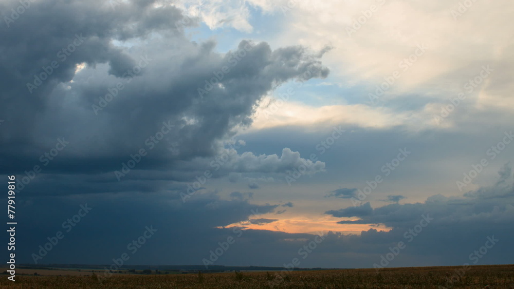 Moving cumulus clouds over field an sunset. Moving cumulus clouds over field an sunset.