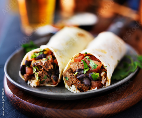 Canvas Print mexican beef burritos with beer in background