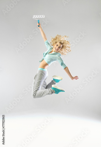 Fototapeta Naklejka Na Ścianę i Meble -  Jumping woman with a paint roller