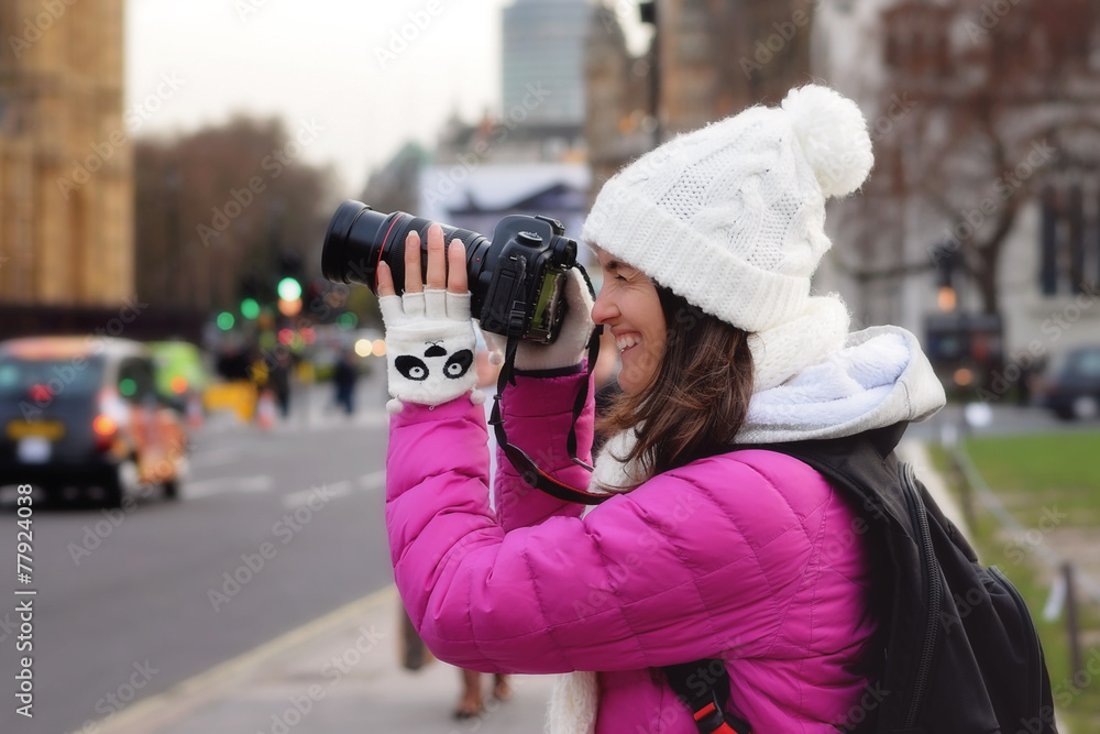 Young woman, taking pictures in London, while traveling on vacat