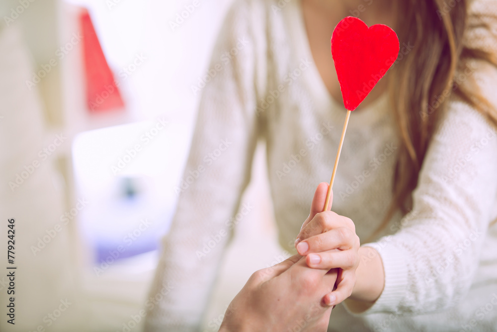 Love couple holding red valentine's heart. Selective focus