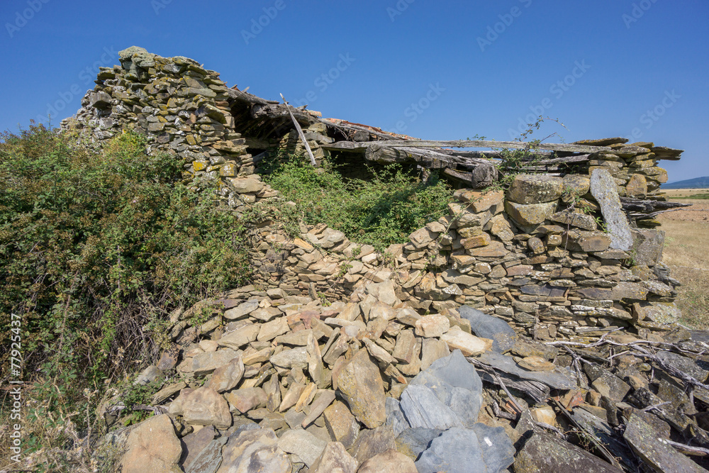 Abandoned old house made with stones, corner view