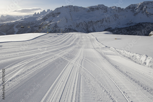 Fresh snow groomer tracks on a ski piste